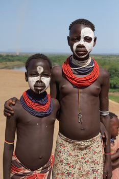 TURMI, ETHIOPIA - NOVEMBER 19, 2014: Karo children with traditional clothings and paintings on November 19, 2014 in Turmi, Ethiopia.