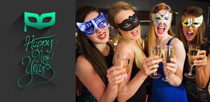 Attractive friends with masks on holding champagne glasses against classy new year greeting