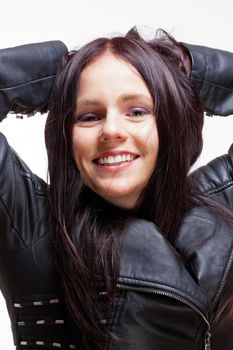 Portrait of a Young Woman in Leather Jacket Smiling - Isolated on Gray