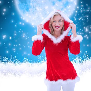 Festive blonde smiling at camera against blue background with vignette
