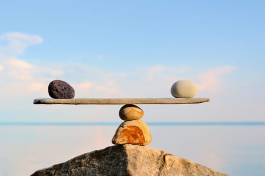 Balancing of pebbles on the top of stone