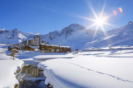 View of Tignes village with sun, France.