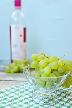 branches of fresh green grape on a wooden surface