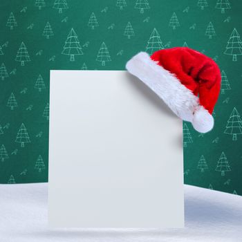 Santa hat on poster against green christmas tree pattern