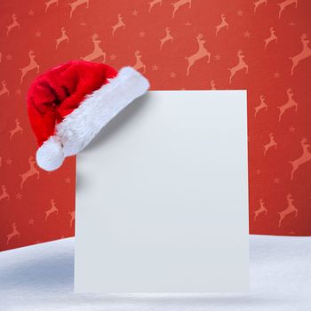 Santa hat on poster against orange reindeer pattern