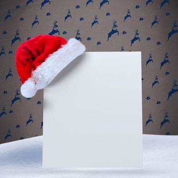 Santa hat on poster against grey reindeer pattern