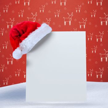 Santa hat on poster against red reindeer pattern