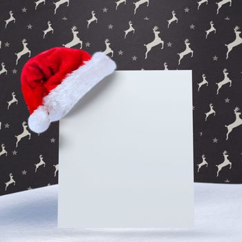 Santa hat on poster against grey reindeer pattern