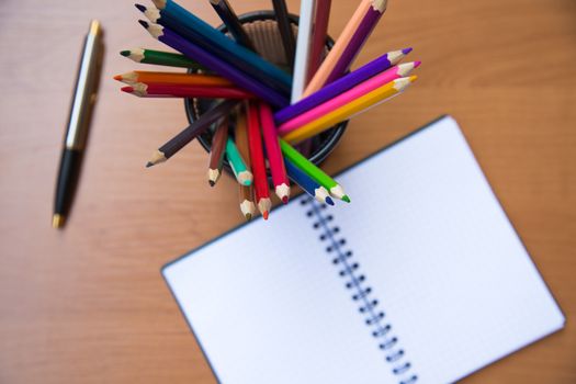 paper notebook with pen on wooden background