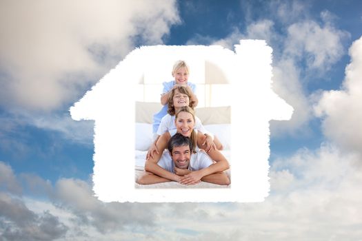 Happy family having fun on a bed against blue sky with white clouds