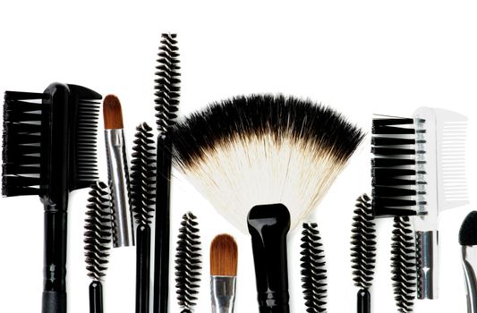Border of Various Make-up Brushes and Applicators closeup on white background