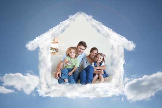 Smiling family watching TV together against cloudy sky with sunshine