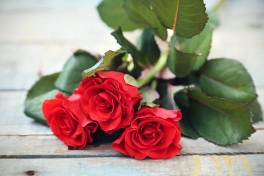 beautyful fresh red roses on wooden background
