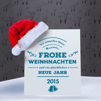 German christmas greeting against grey reindeer pattern