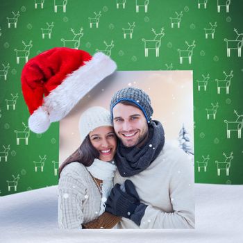 young winter couple against green reindeer pattern