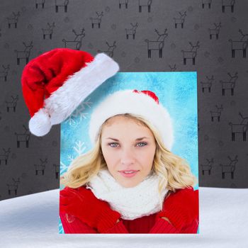 happy festive blonde  against grey reindeer pattern
