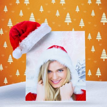 pretty girl smiling in santa outfit against orange tree pattern