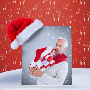 happy festive man with gifts against red reindeer pattern