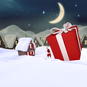 Santa delivering large gift against cute christmas village at night