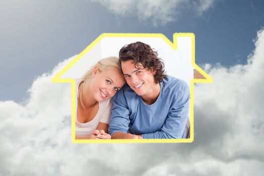 Couple organizing their future home against bright blue sky with clouds