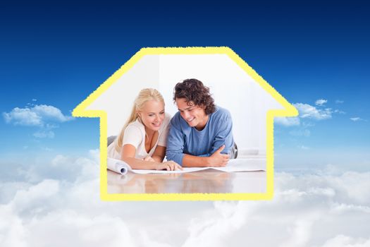 Smiling couple getting ready to move in a new house against bright blue sky over clouds