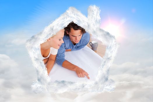 Cute man showing a point on a plan to his fiance against blue sky with white clouds