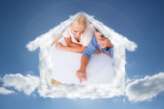 Young man showing a point on a plan to his fiance against cloudy sky with sunshine