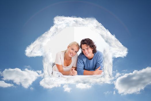 Cute couple moving in a new house against cloudy sky with sunshine