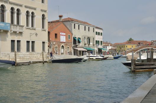 Boats in canal in Murano, a series of islands linked by bridges in the Venetian Lagoon, northern Italy.