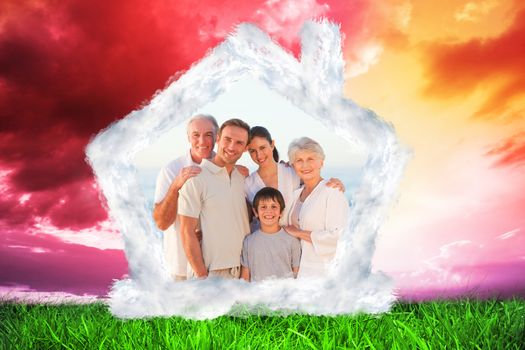 Portrait of a smiling family at the beach against green grass under red and purple sky