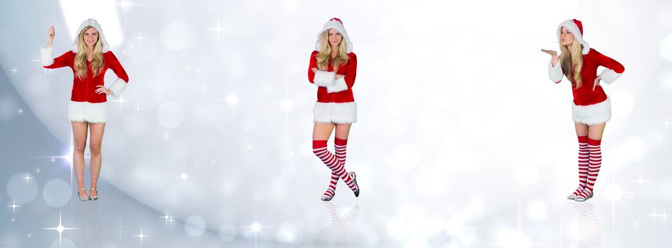 Pretty girl in santa outfit holding hand up against lights twinkling in room