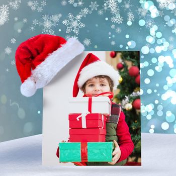 Cute festive little boy smiling at camera against light design shimmering on blue