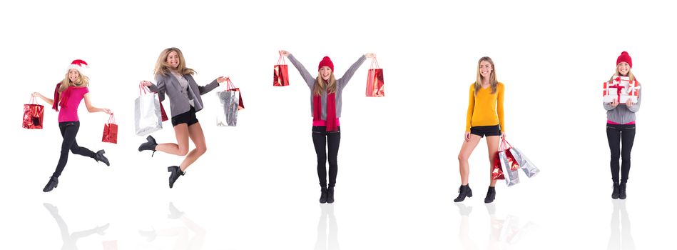 Composite image of festive blonde carrying gift bags