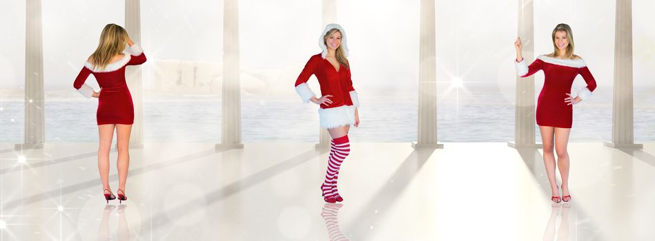Pretty girl smiling in santa outfit against twinkling lights over balcony with columns