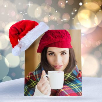 Brunette with cover holding mug against light glowing dots design pattern