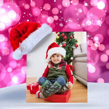 Cute festive little boy smiling at camera against light glowing dots on pink