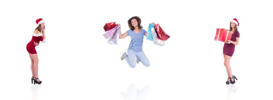 Composite image of festive brunette holding christmas gift