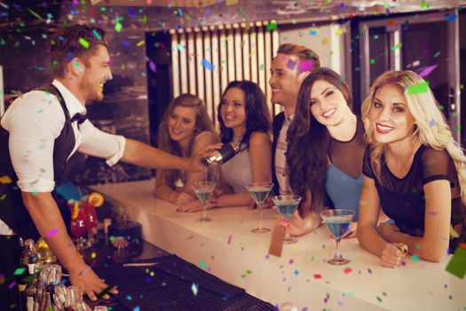 Attractive friends being served cocktails against flying colours