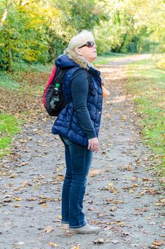 Blonde woman with backpack while hiking.