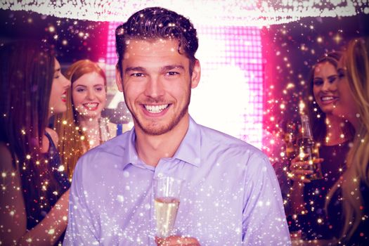 Man toasting with champagne against gold and red lights