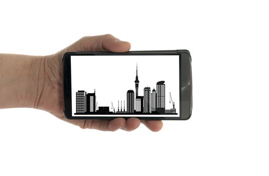 female hand with mobile phone isolated on white with Auckland skyline