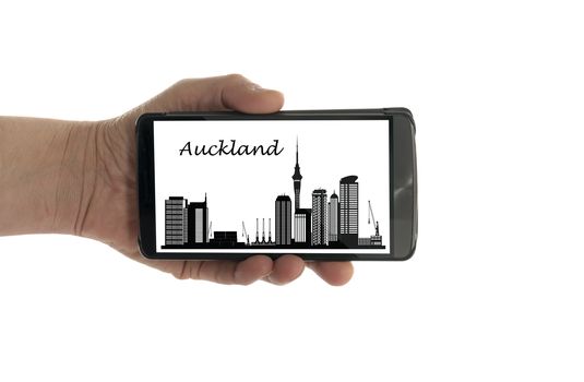 female hand with mobile phone isolated on white with Auckland skyline