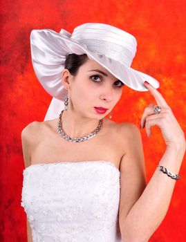 young girl in a wedding dress and hat