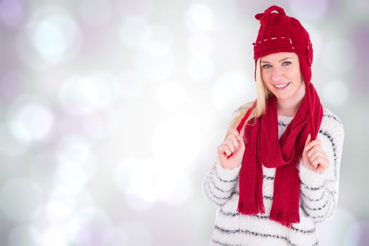 Festive blonde smiling at camera against purple abstract light spot design