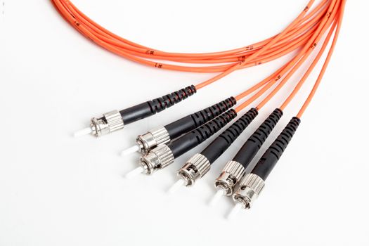 group of fiber optic ST connectors on orange patchcord 