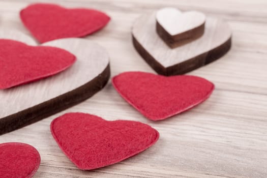 valentine's wooden and fabric hearts on a wooden background , valentine's day , day valentine postcard with space for text