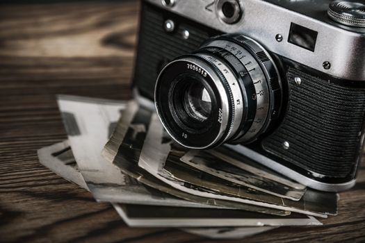 old camera and old pictures wooden table