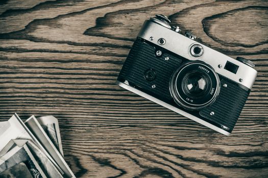 old camera and old pictures wooden table