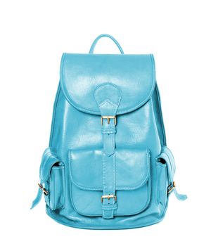 Cyan color leather backpack standing isolated on white background