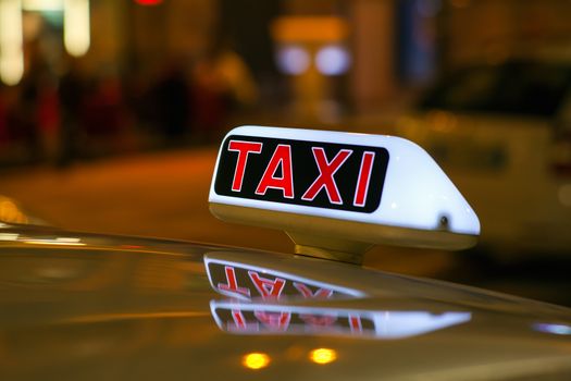 Taxi sign from parked taxi in the Milan street at night